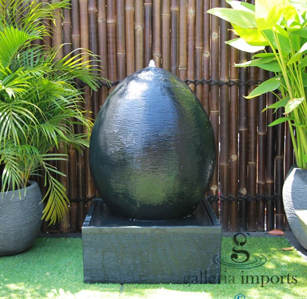 Multi-tiered Bali water feature crafted from durable GRC, elegantly cascading water in a residential garden setting.