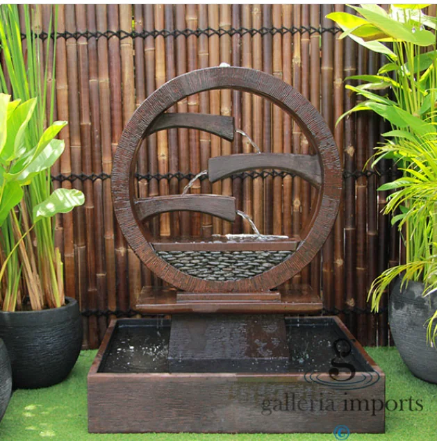 Traditional Balinese water fountain with intricate stone carvings, set in a serene garden, embodying Indonesian cultural art.